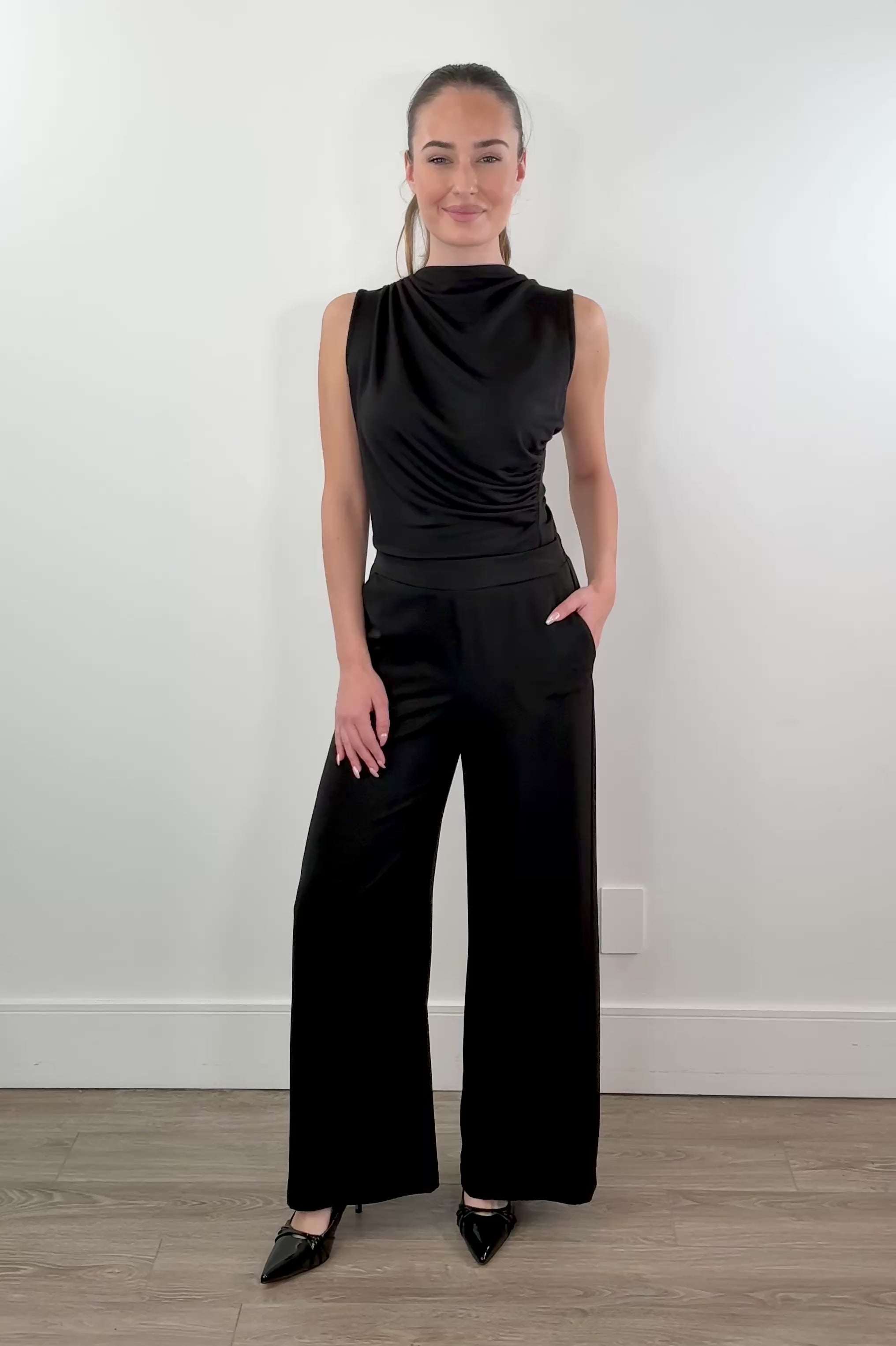 video of woman wearing stretch satin pants in black