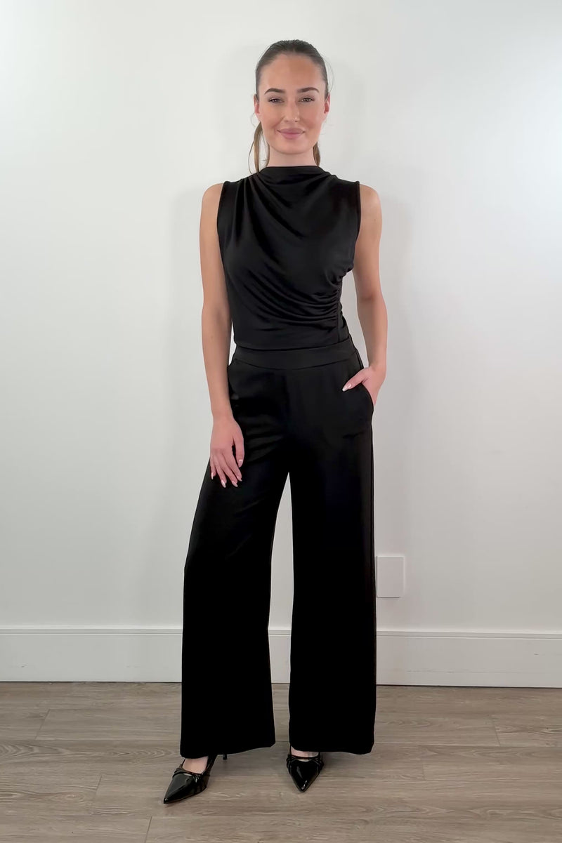 video of woman wearing stretch satin pants in black