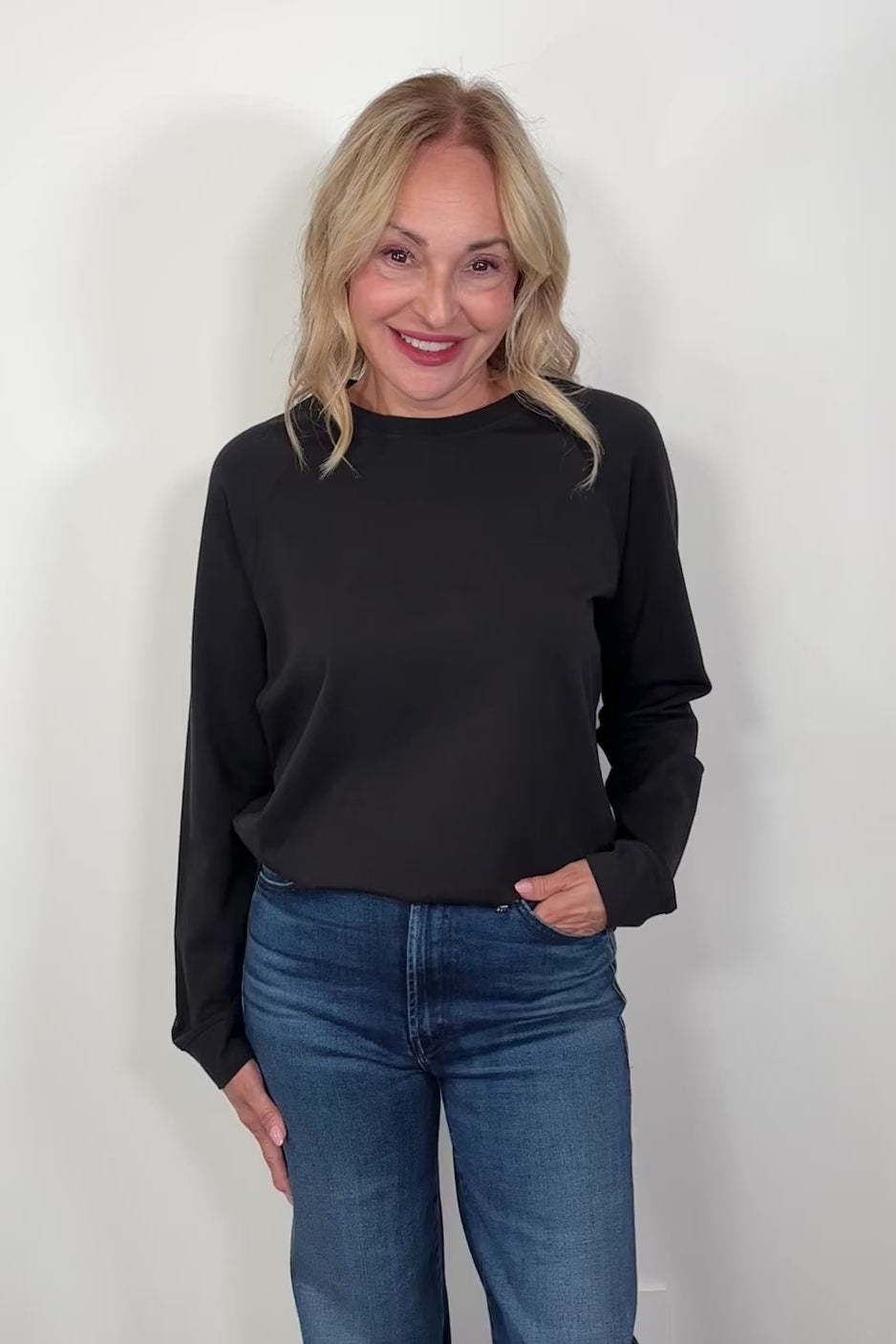Video of a woman wearing a black pullover 