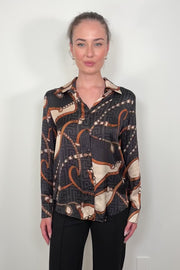 Video of a woman wearing a printed button up shirt tucked in