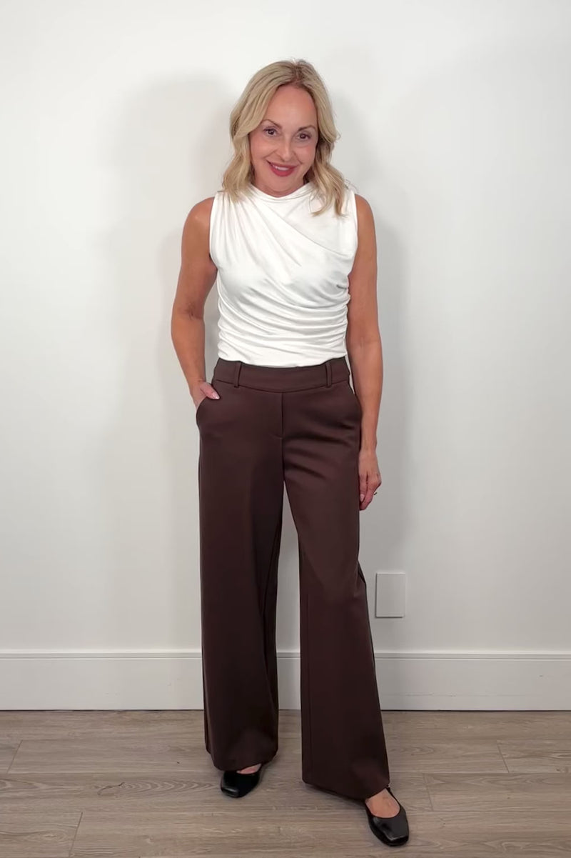 video of a woman wearing a brown wide-leg pant