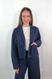 video of a woman wearing a navy blue 100% cotton blazer 