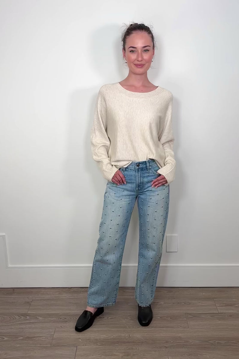 Video of woman wearing blue denim jeans with silver studs