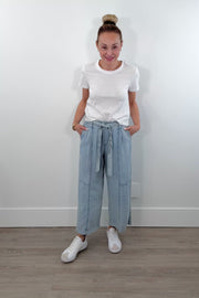 Video of a woman wearing light blue chambray wide-leg pants with a drawstring waist