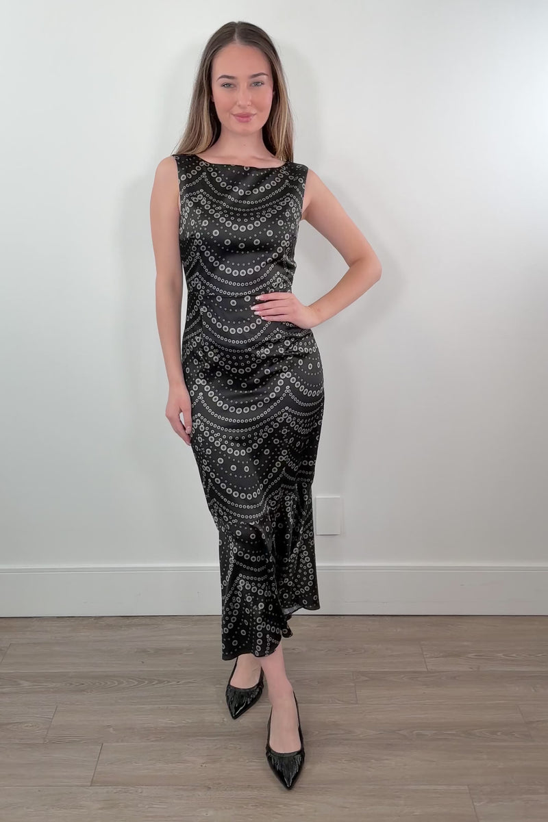 video of a woman wearing a black dress  with white patterns