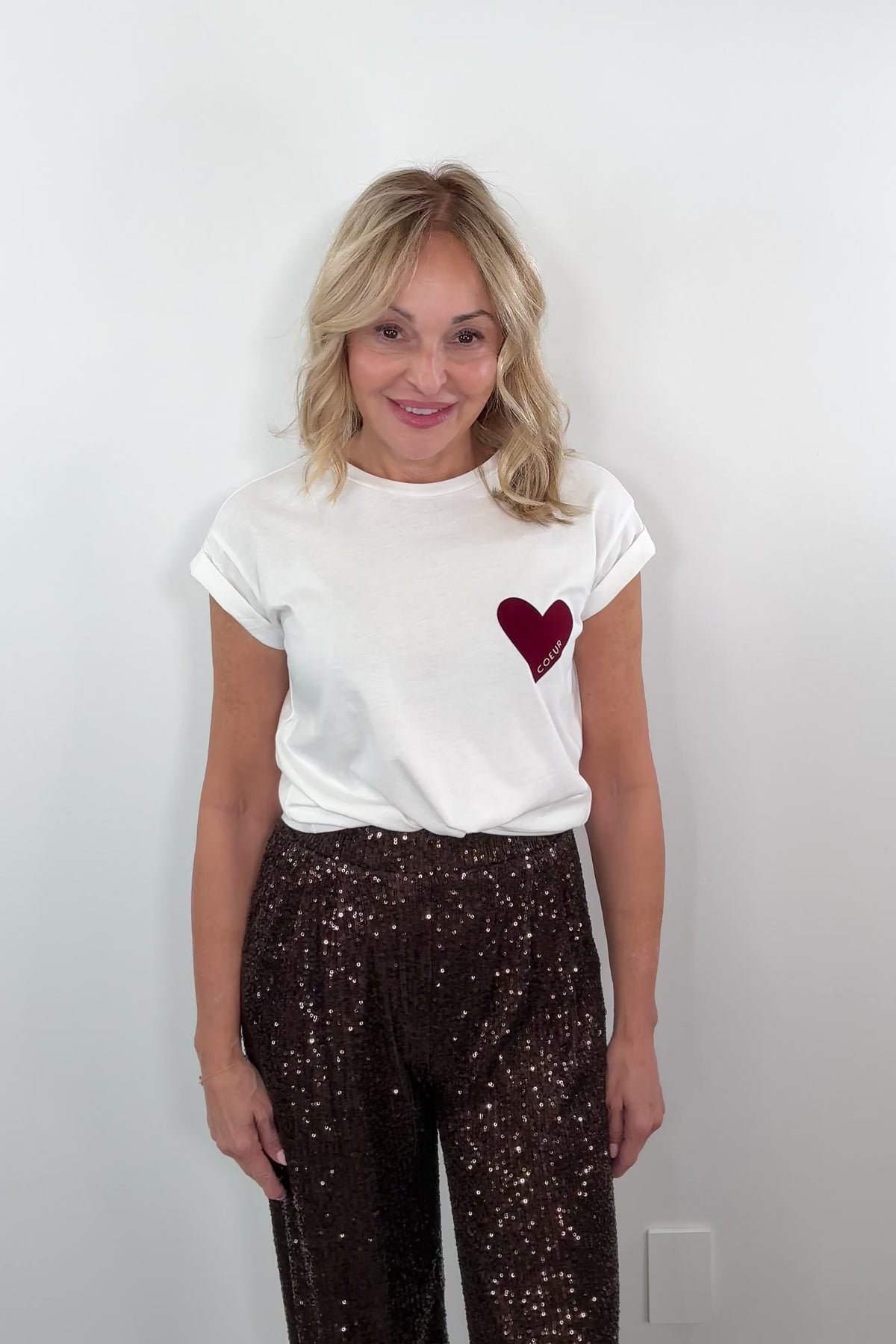 video of a woman wearing a graphic tee wit a red heart