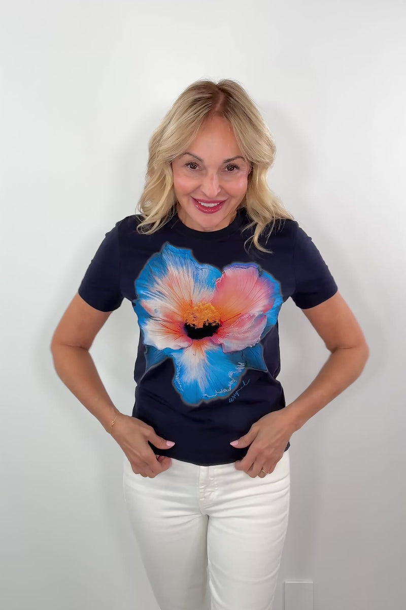 video of a woman wearing a short sleeve navy tee with a flower print