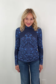 video of a woman wearing a long sleeve turtleneck mesh top with patterns