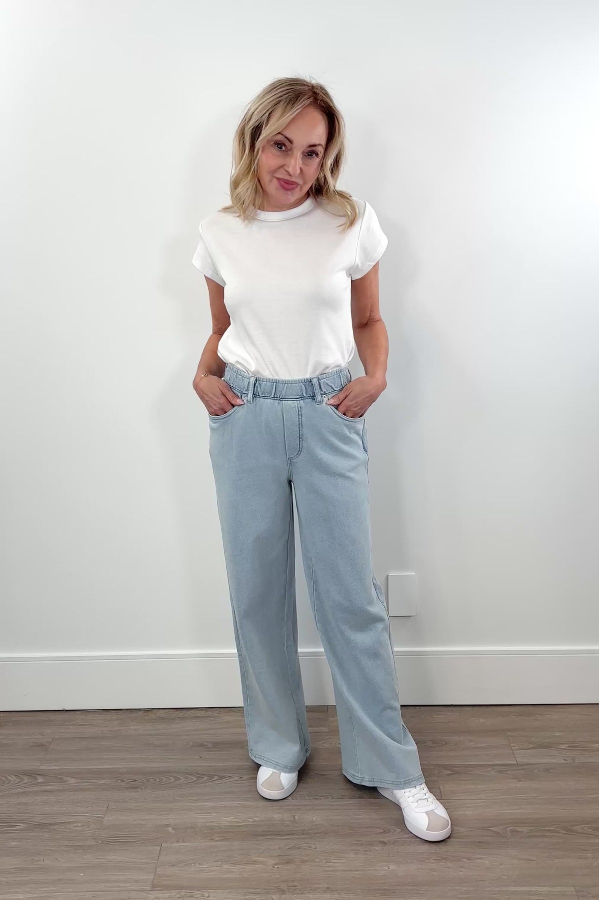 Video of light blue wide leg denim pants with elastic waistband and front pockets