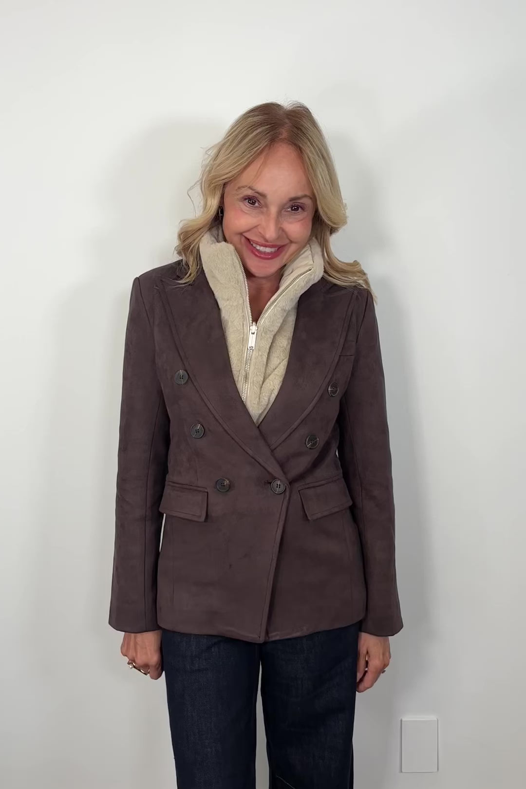 video of woman wearing a brown blazer and ribbed vest