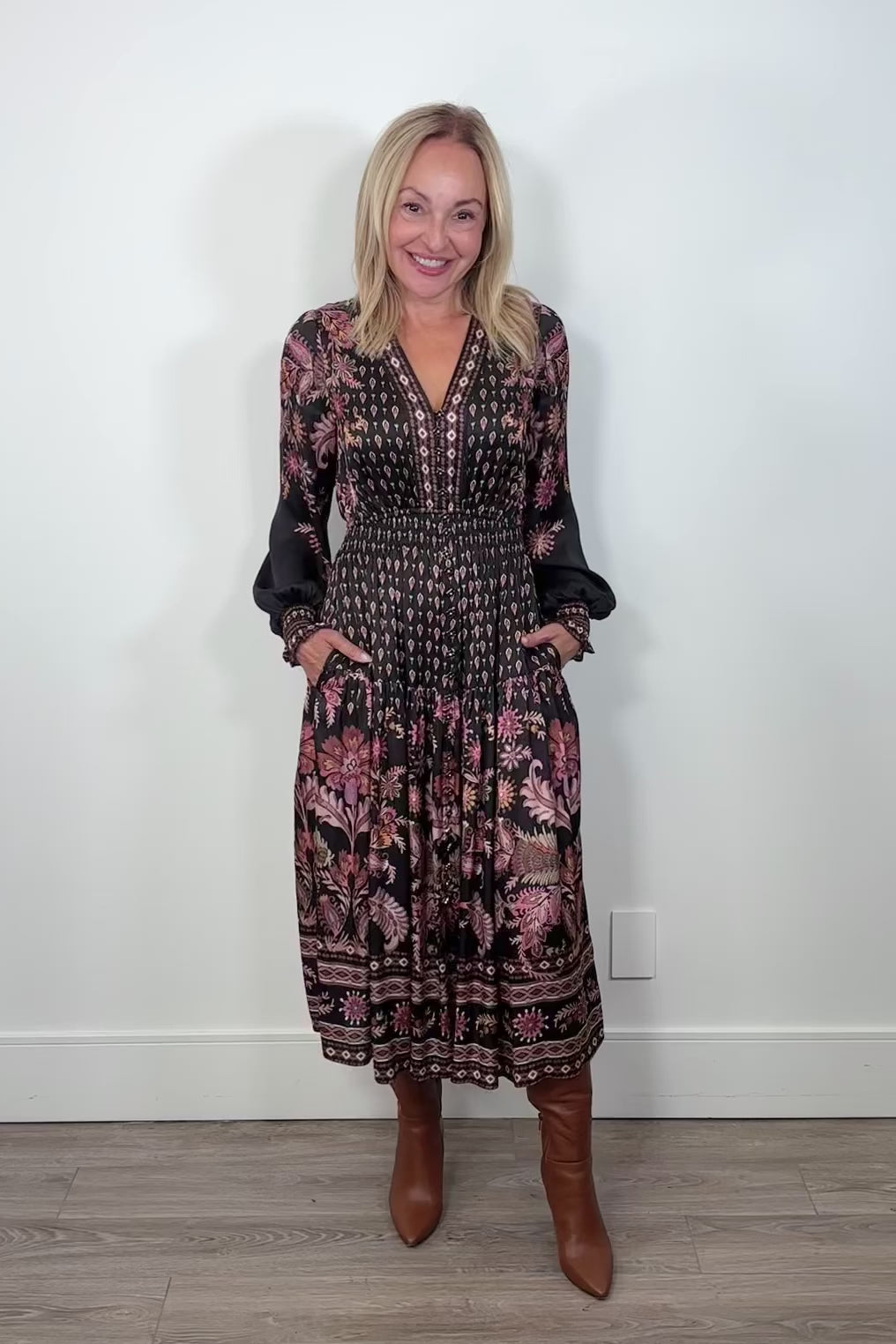 Video of a woman wearing a silk midi long sleeve patterned dress