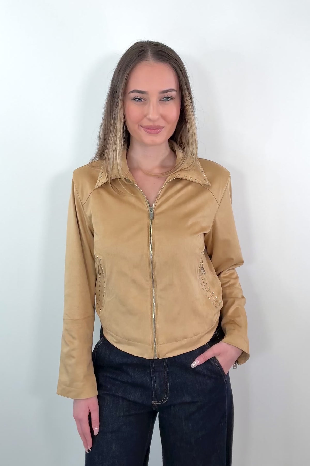 video of a woman wearing a faux suede tan leader jacket with stud details