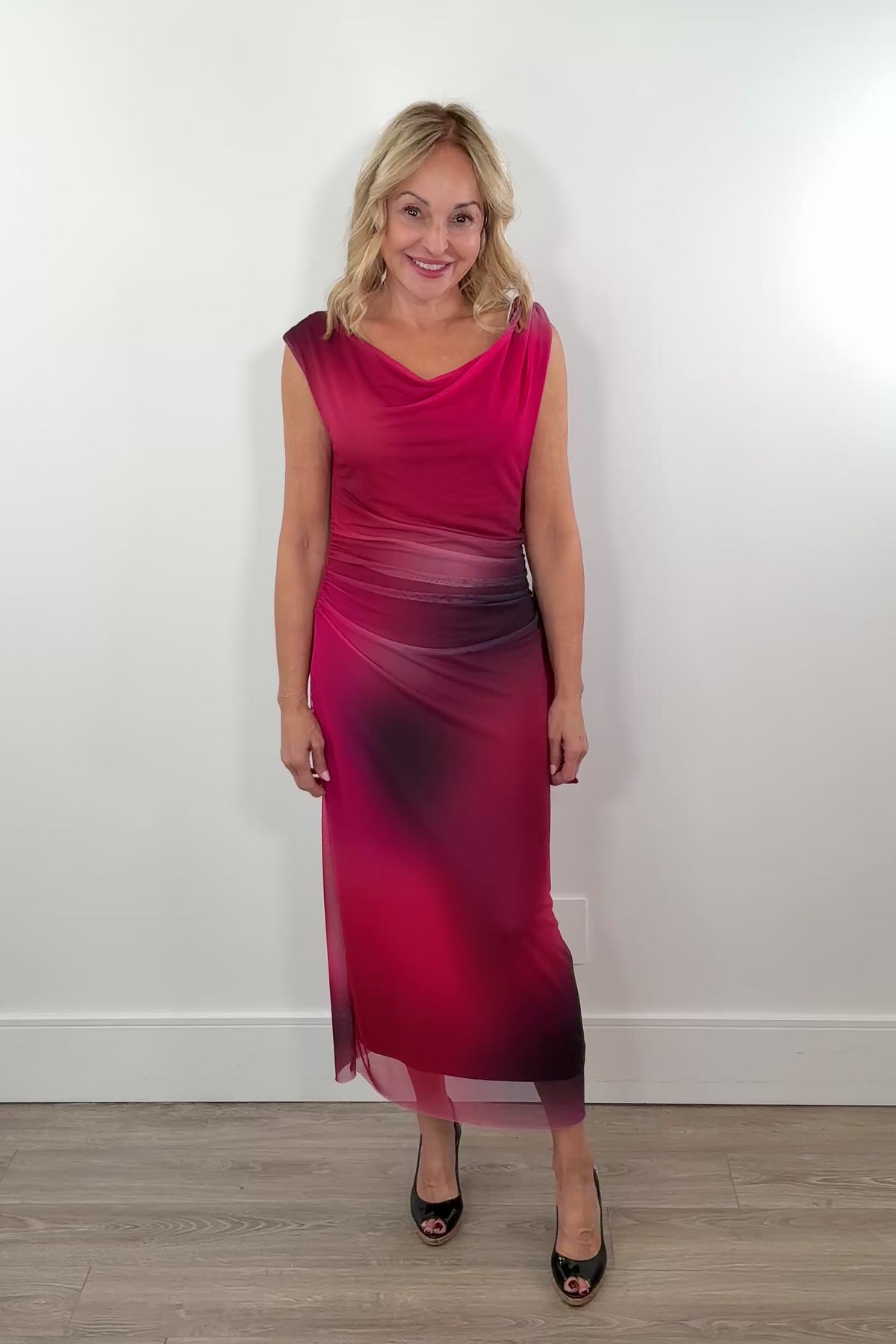 video of a woman wearing a red and black maxi lined mesh dress. with detail in the strap