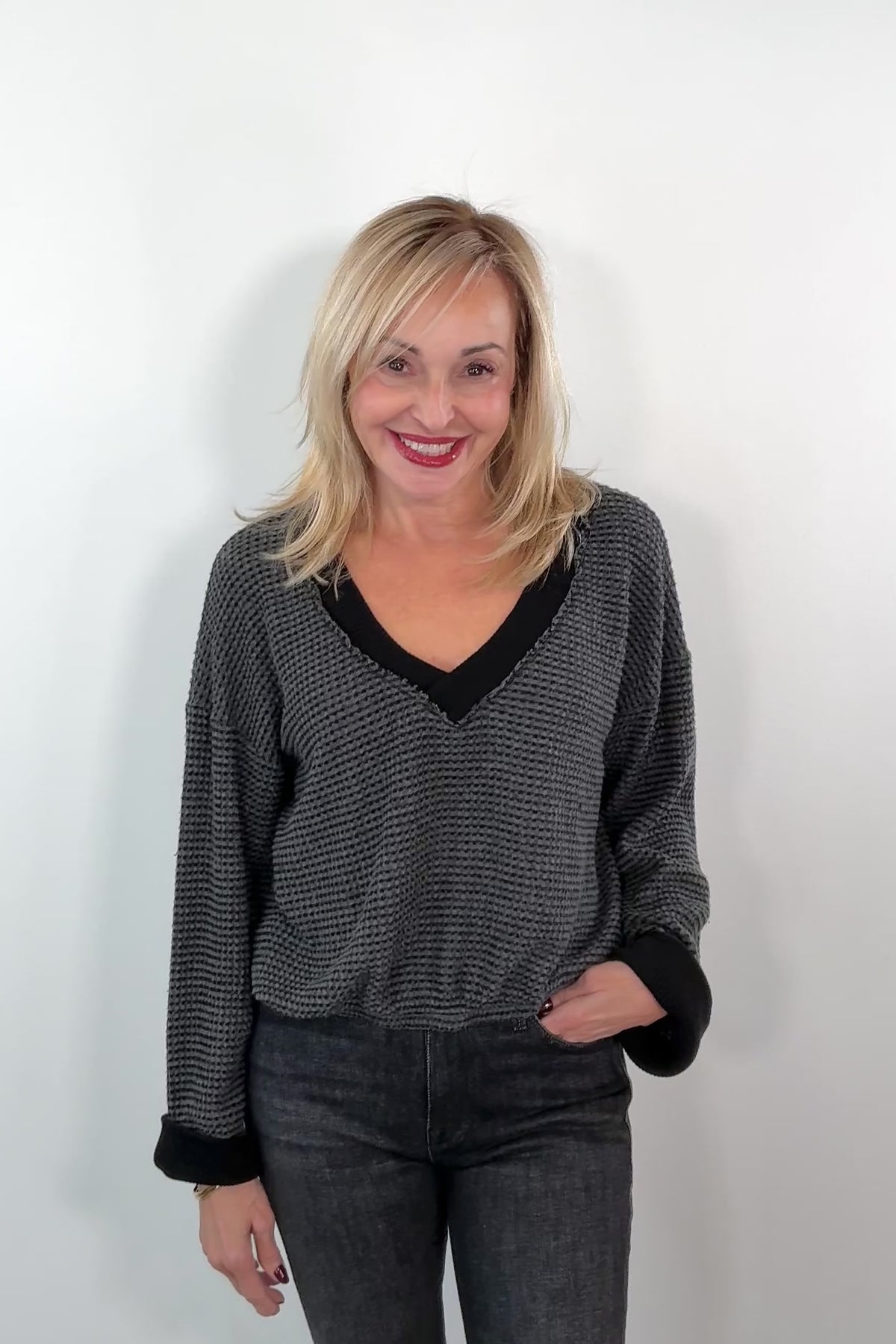 video of a woman wearing a black and gray top with black trim 