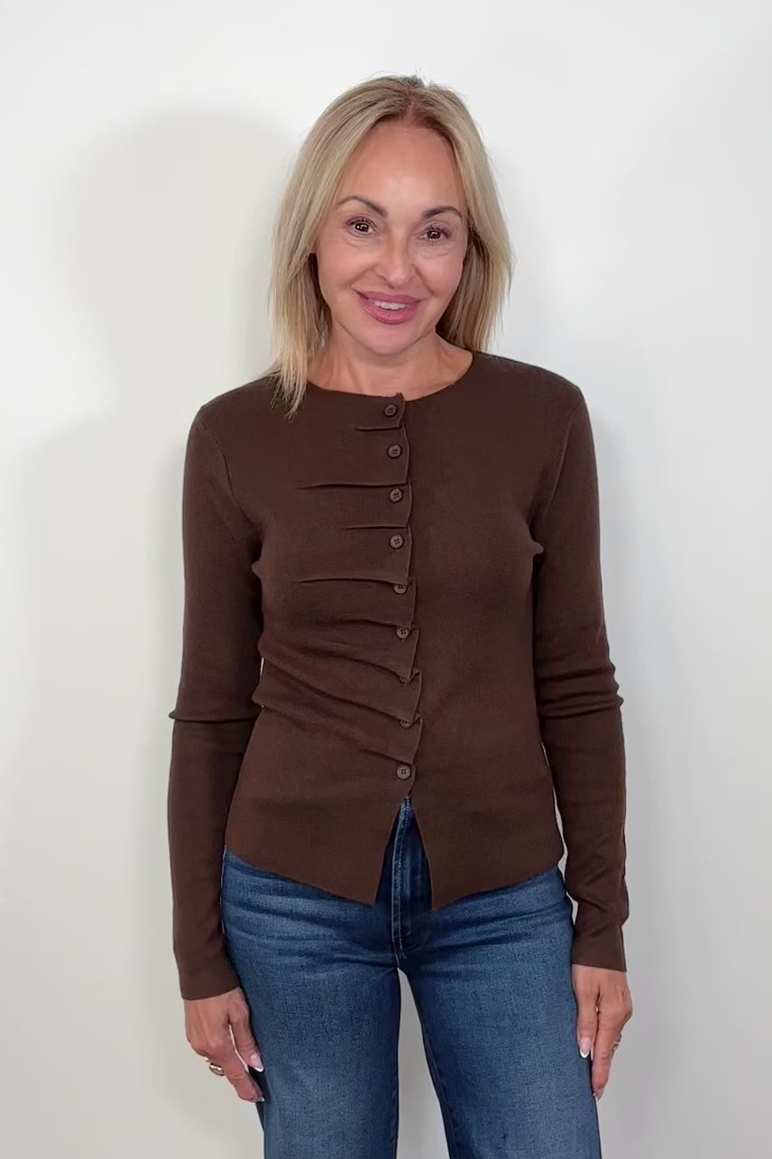 video of woman wearing a rouched in the buttons brown long sleeve knitted top
