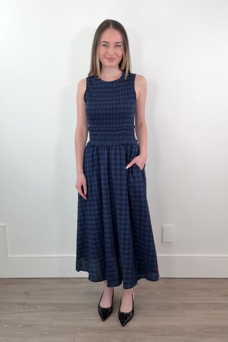 video of a woman wearing a blue saquarema gingham midi dress
