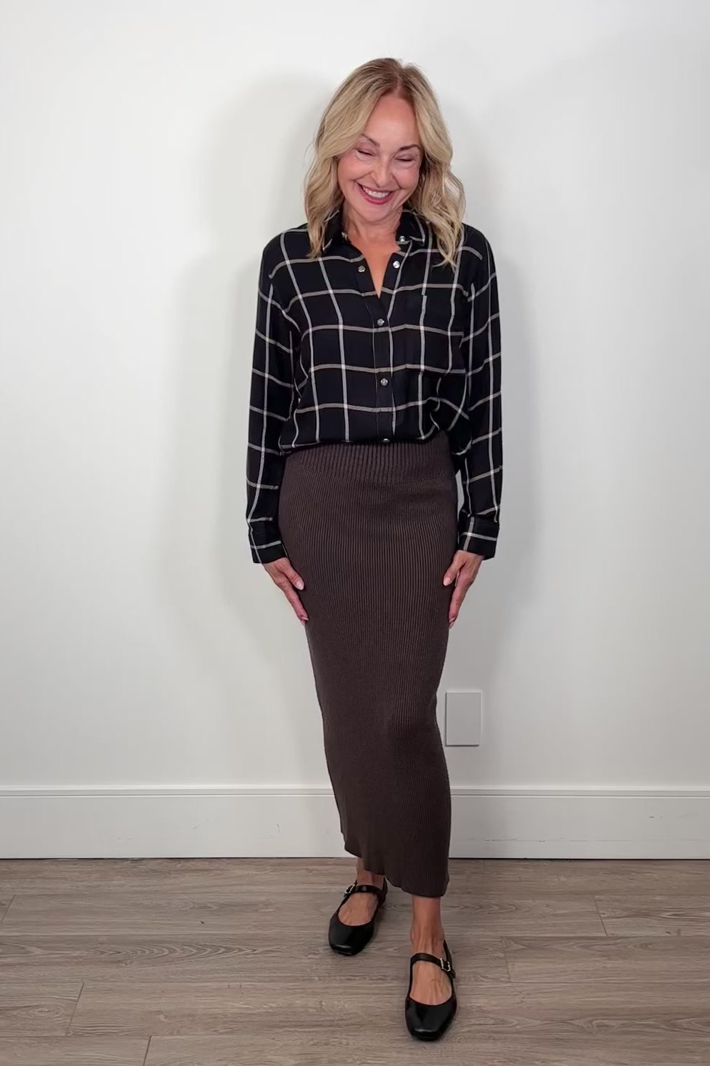 video of a woman wearing a brown ribbed midi skirt