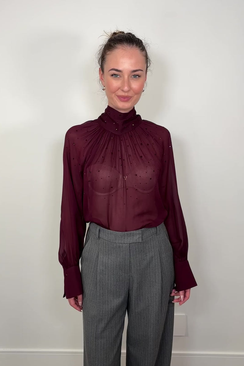 Video of omwomanwearing a mesh lingerie sleeve burgundy 