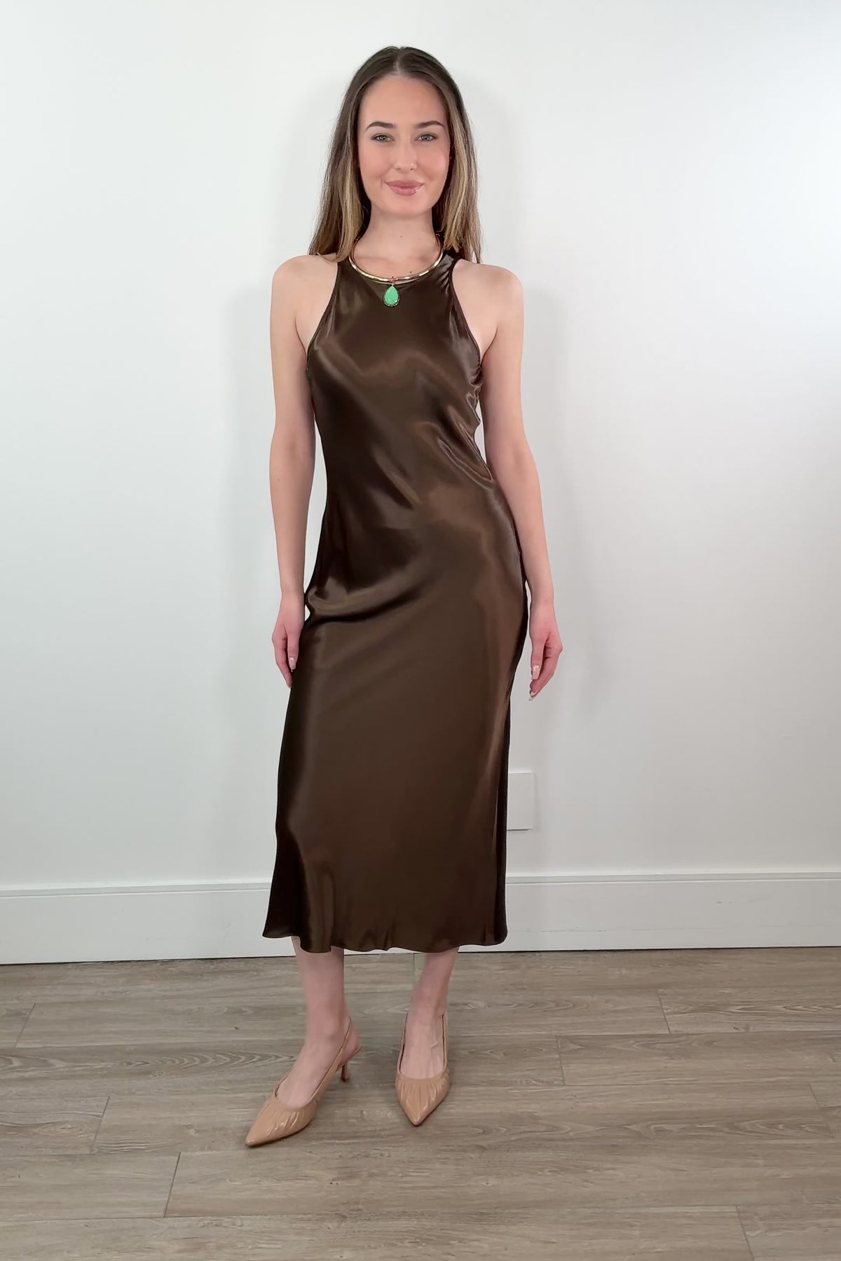 video of a woman wearing a brown satin dress
