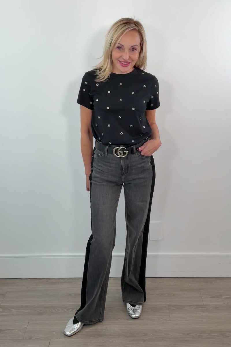 video of a woman wearing washed black relaxed straight leg jeans with a black stripe on the sides