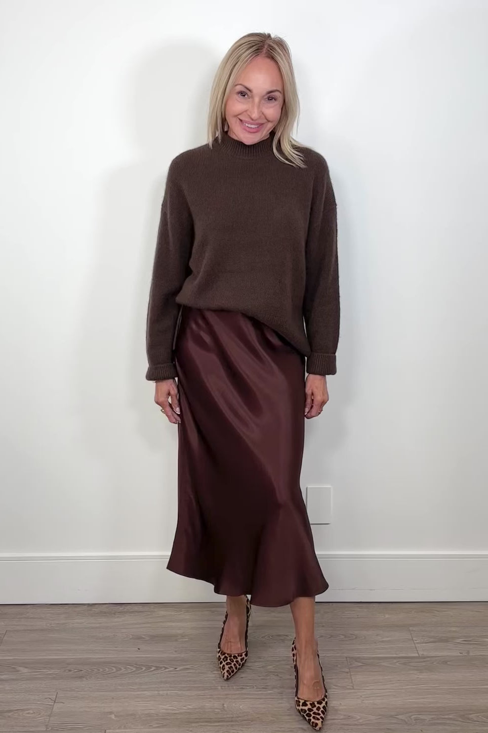 Video of woman wearing a brown satin skirt