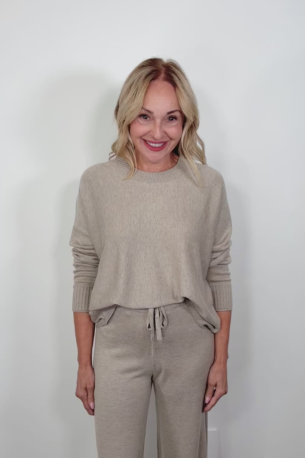 video of a woman wearing a greige crew neck