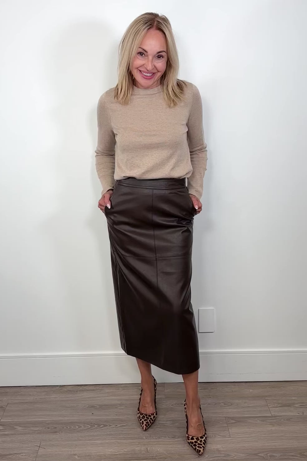 Video of a person wearing and showing a brown leather skirt