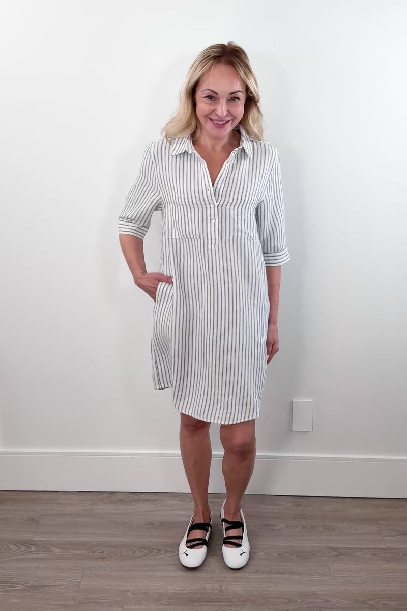 Video of a Woman wearing a striped shirt dress with a collar, buttoned neckline, and three-quarter sleeves.
