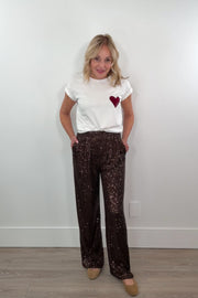 video of a woman wearing brown sequin pants