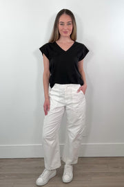 Video of woman wearing white straight leg cargo pants with string waistband