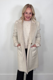 Video of a woman wearing a faux leather reversible trench coat