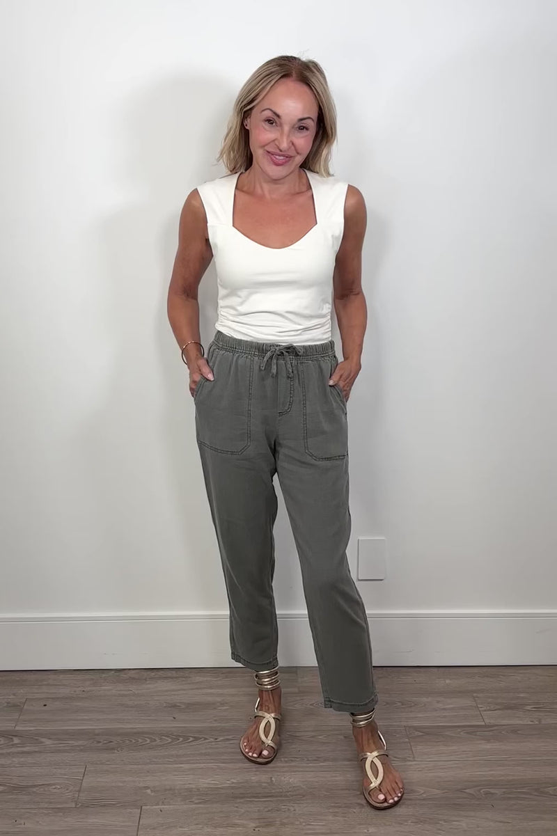 Video of a woman wearing green straight leg pants