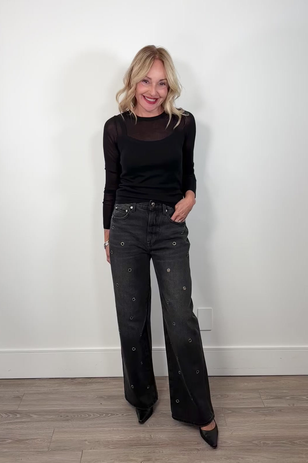 video of a woman wearing washed black baggy jeans