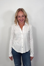 Video of a woman wearing a white knit slub shirt
