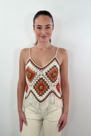 video of woman wearing a white, beige, orange and brown crochet frayed tank top