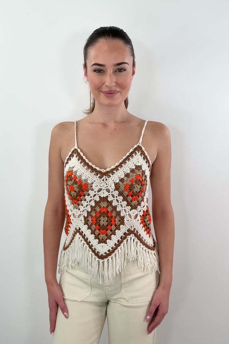 video of woman wearing a white, beige, orange and brown crochet frayed tank top