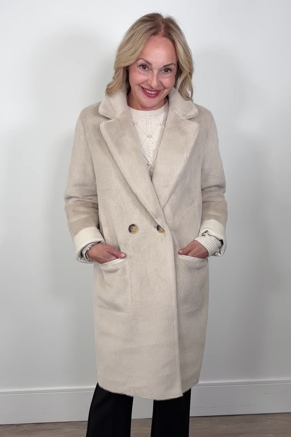 Video of woman wearing a fluffy trench coat