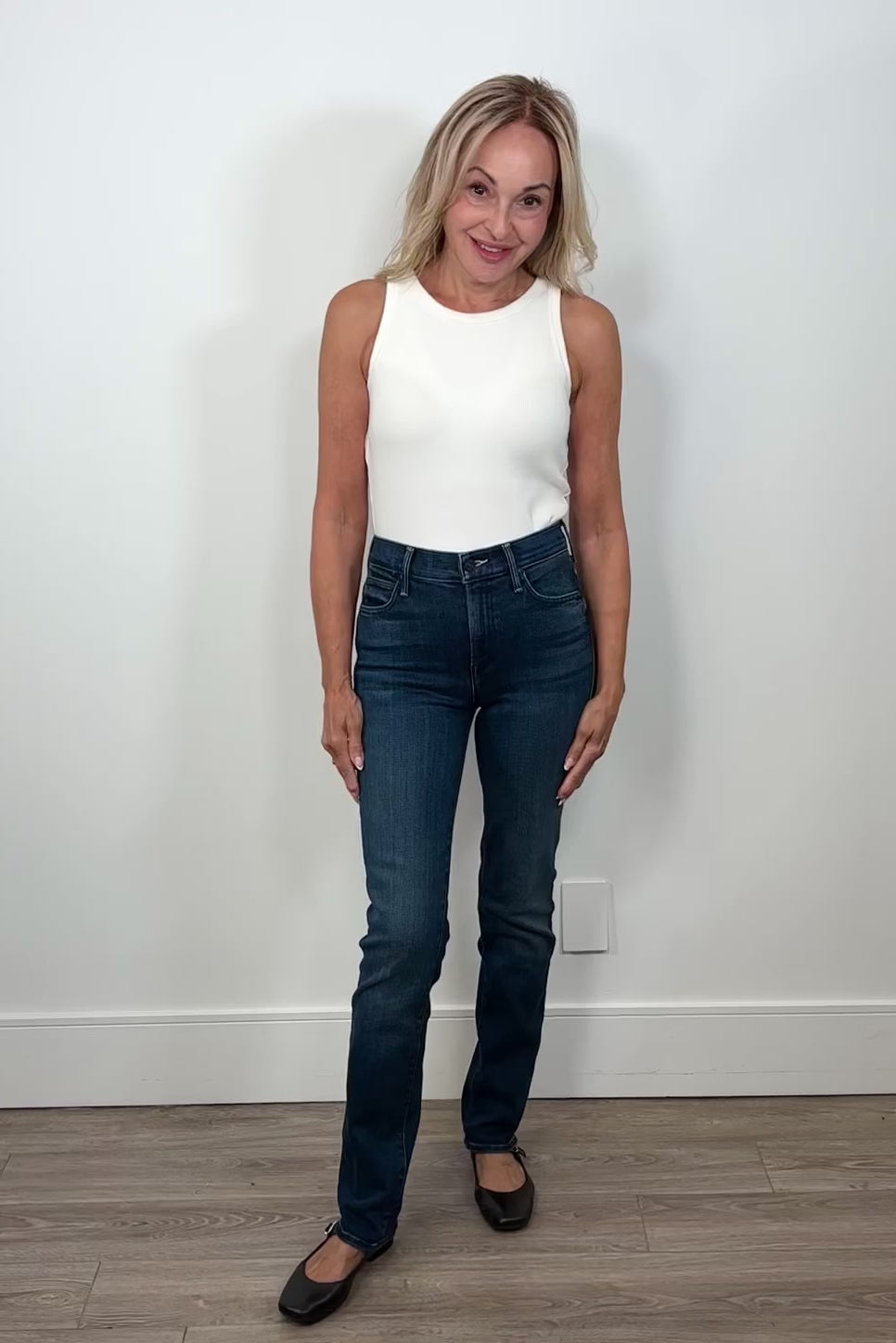Video of woman wearing mid rise, dark blue wash, straight legged jean