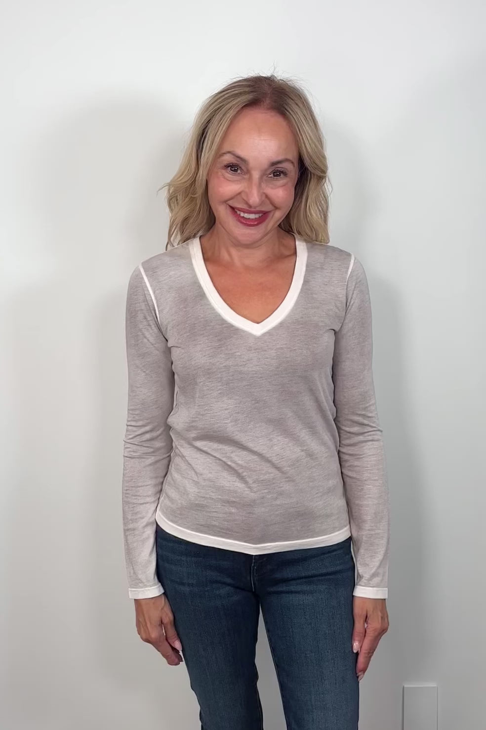 Video if a woman wearing a light gray long-sleeve shirt 