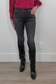 video of a woman wearing washed black fitted jeans and a red top