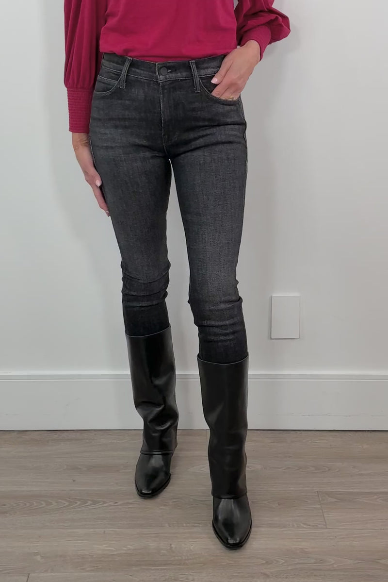 video of a woman wearing washed black fitted jeans and a red top