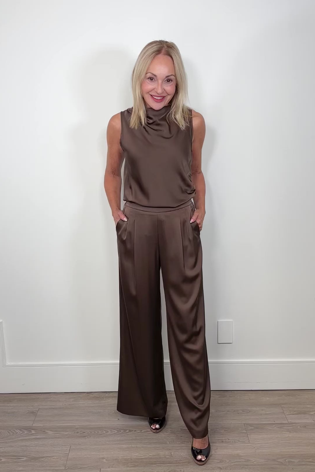 Video of woman wearing a brown satin set outfit on a white background