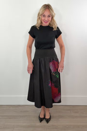 video of a woman wearing a black poplin skirt with a floral design on the side