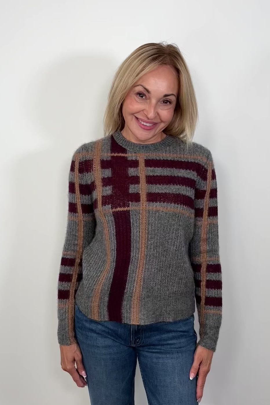Video of a woman wearing a gray plaided silk and cashmere sweater blend turning to show the back