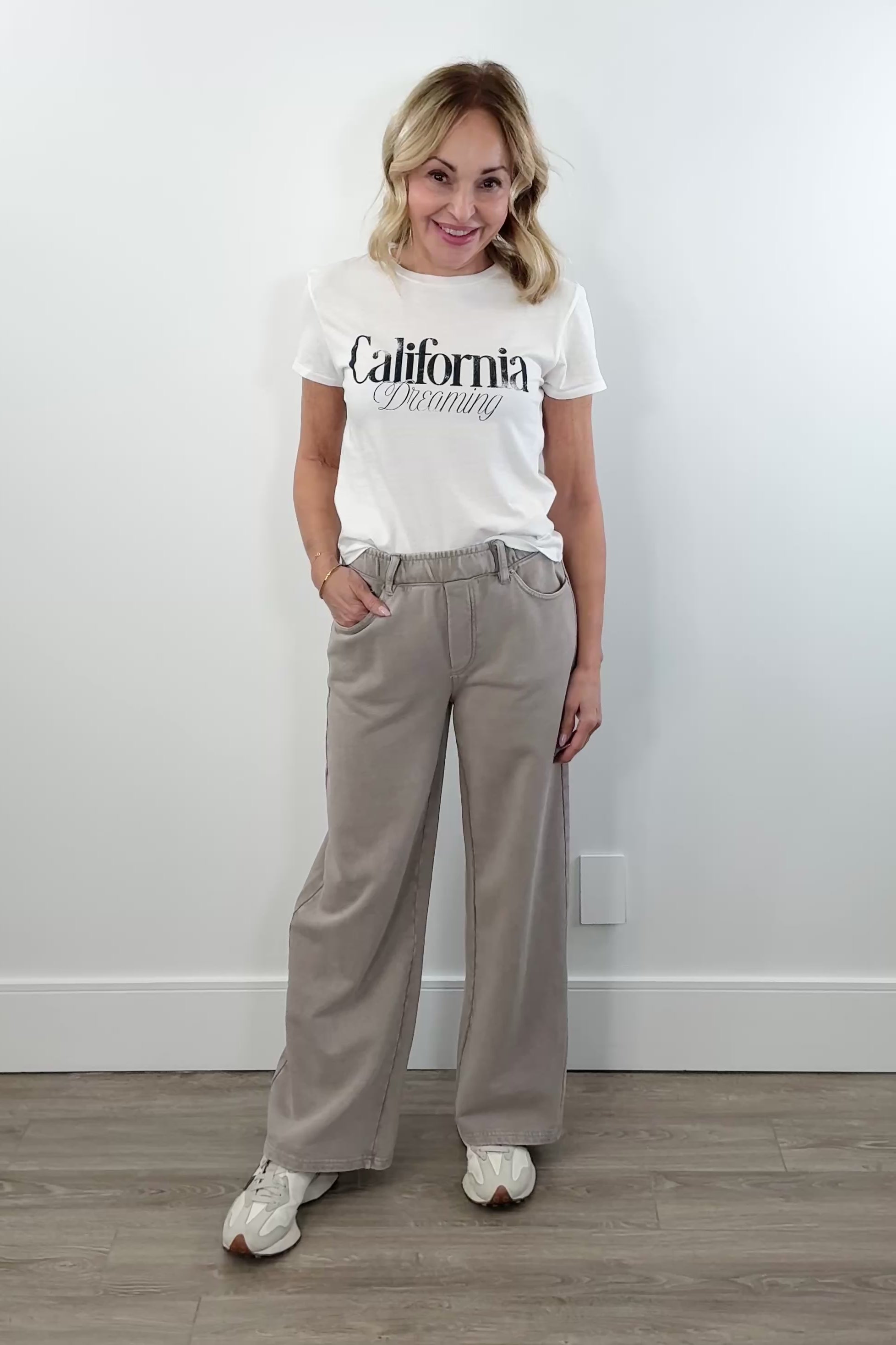 video of Woman wearing taupe wide leg pants with elastic waistband and front pockets