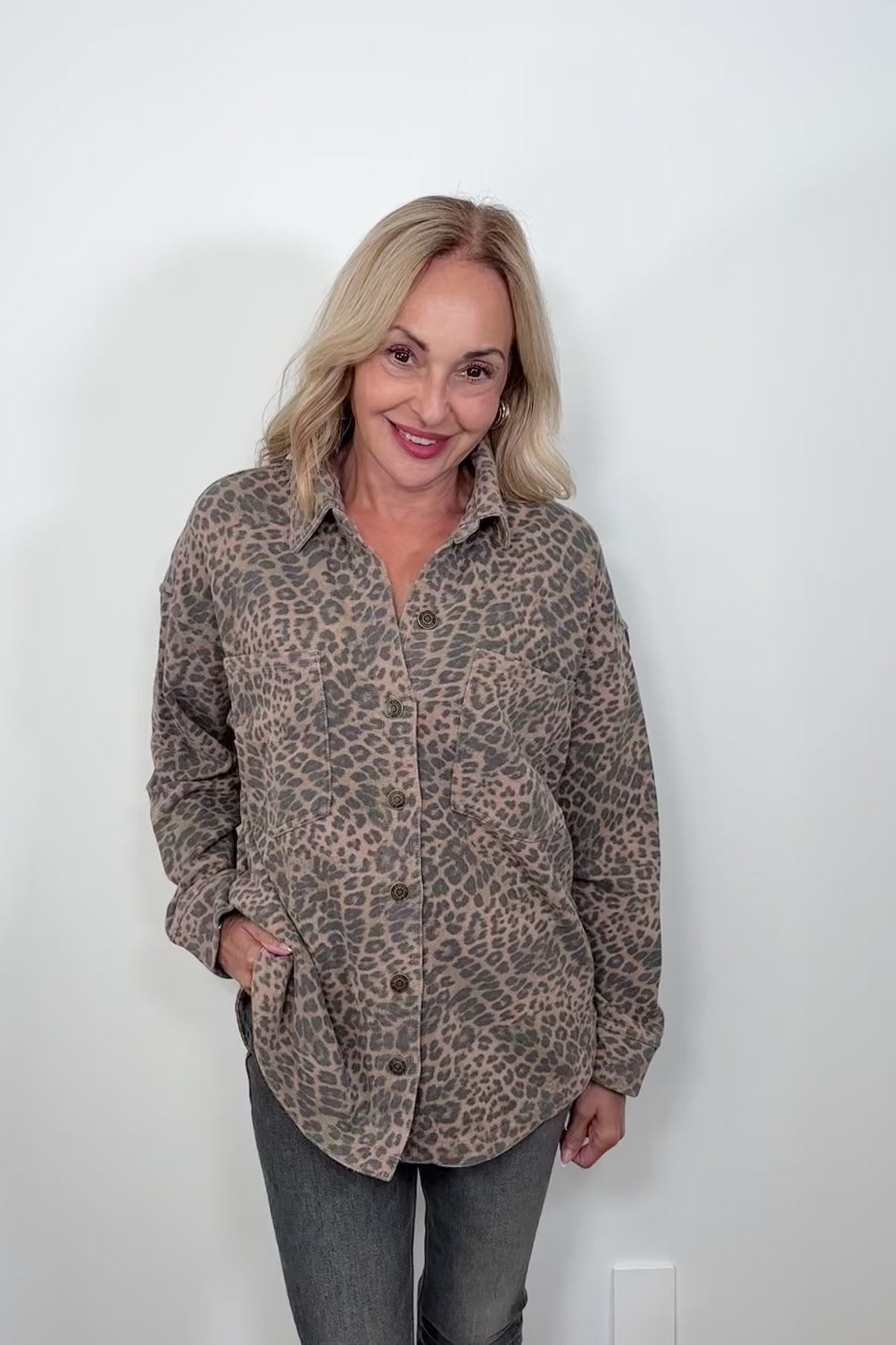 Video of woman wearing a denim leopard print jacket
