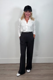 Video of a woman wearing a wide leg black sweatpant