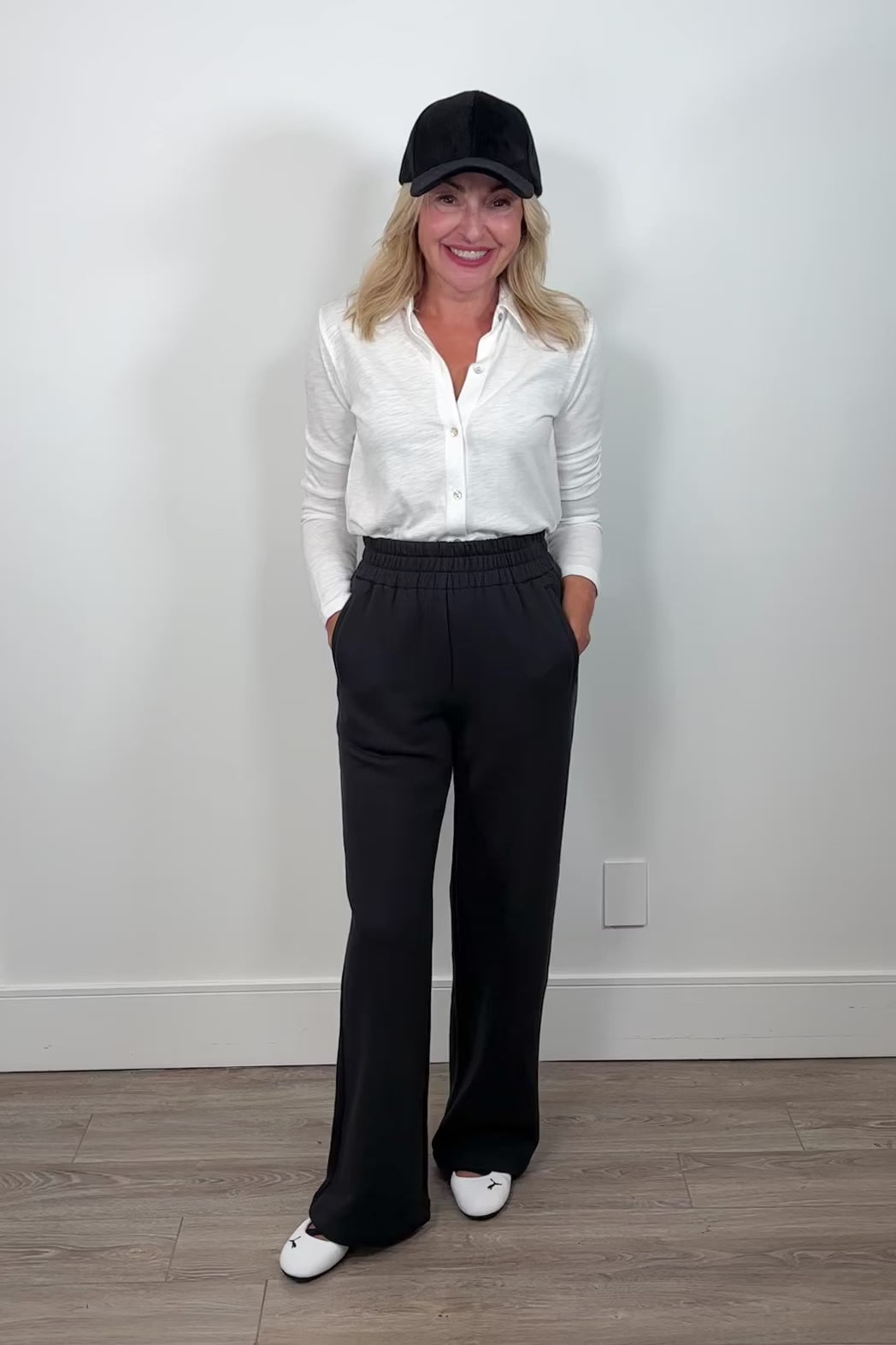 Video of a woman wearing a wide leg black sweatpant