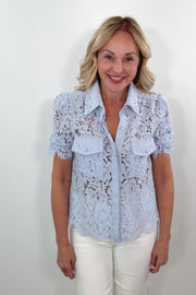 Video of Woman wearing a light blue button up lace shirt with pocket details