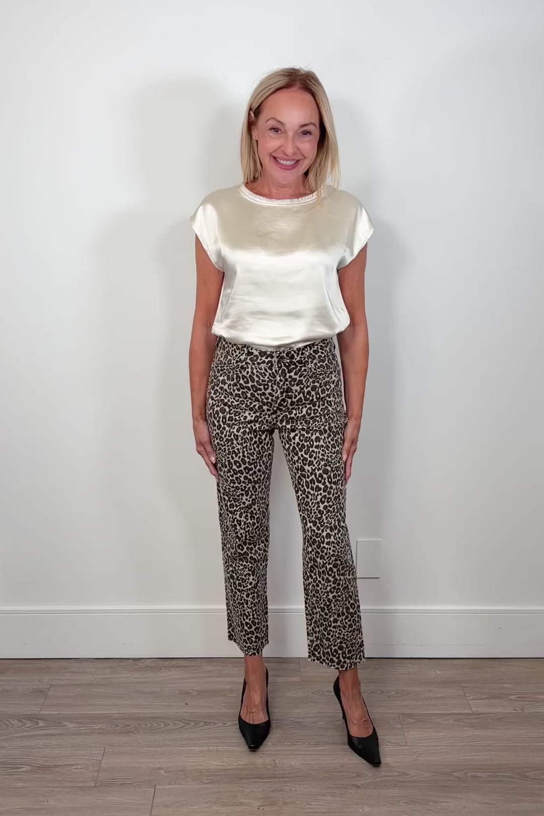 Video of a woman wearing a crop pair of leopard print jeans